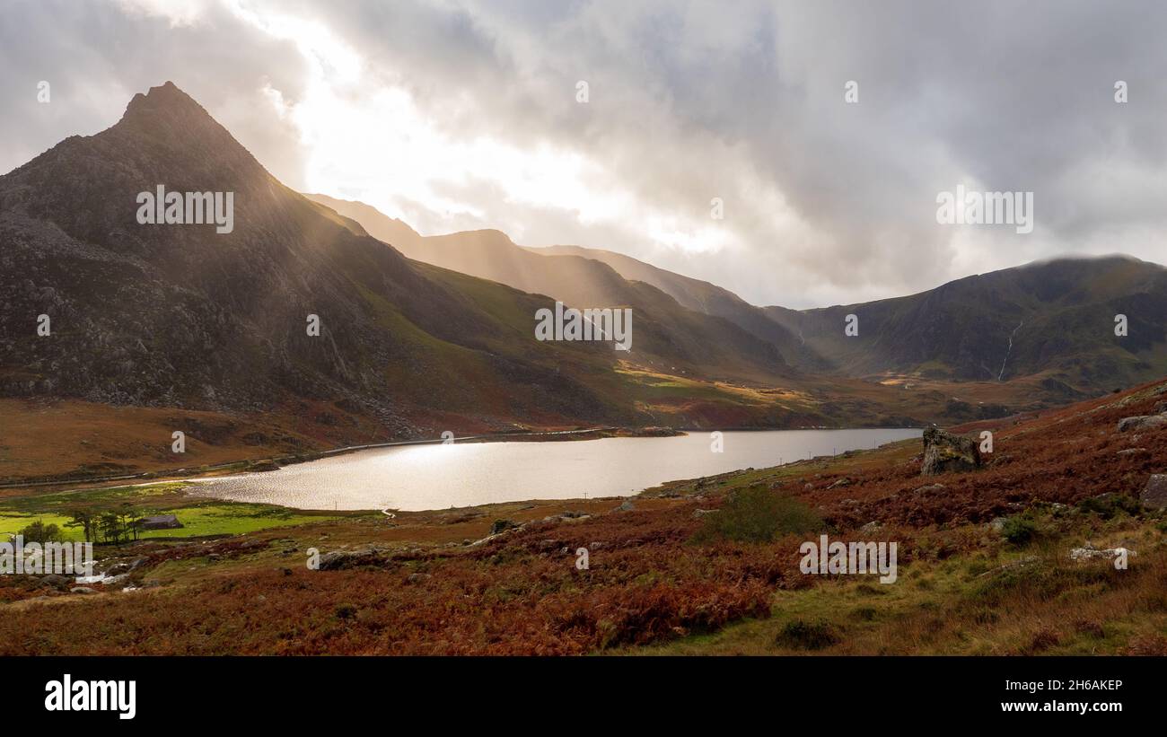 Sun breaking through the clouds above the Ogwen valley in Wales on an Autumn day Stock Photo