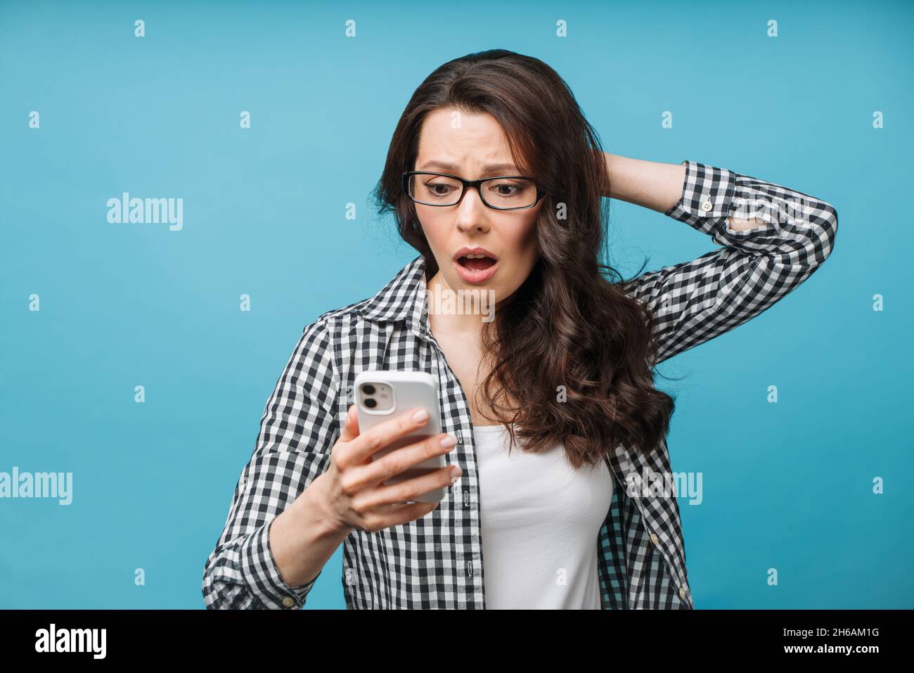 Upset woman who found out the bad news. Loss of finances, bankruptcy of a business, a fall in the exchange rate of securities. The brunette looks at Stock Photo