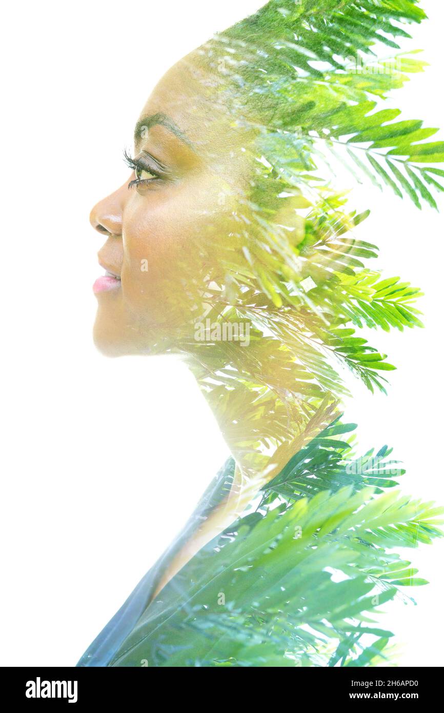A profile portrait of a young woman in a double exposure technique ...