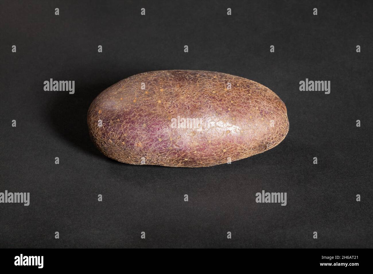 red potato on black background Stock Photo