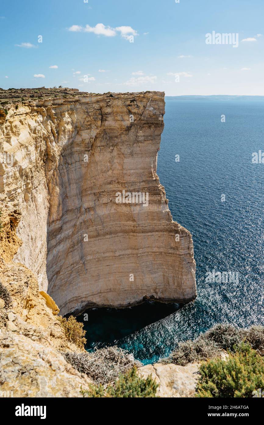 Rocky limestone coastline of Gozo island and Mediterranean Sea with turquoise blue water and caves.Great spot for hiking along Maltese coast.Popular w Stock Photo
