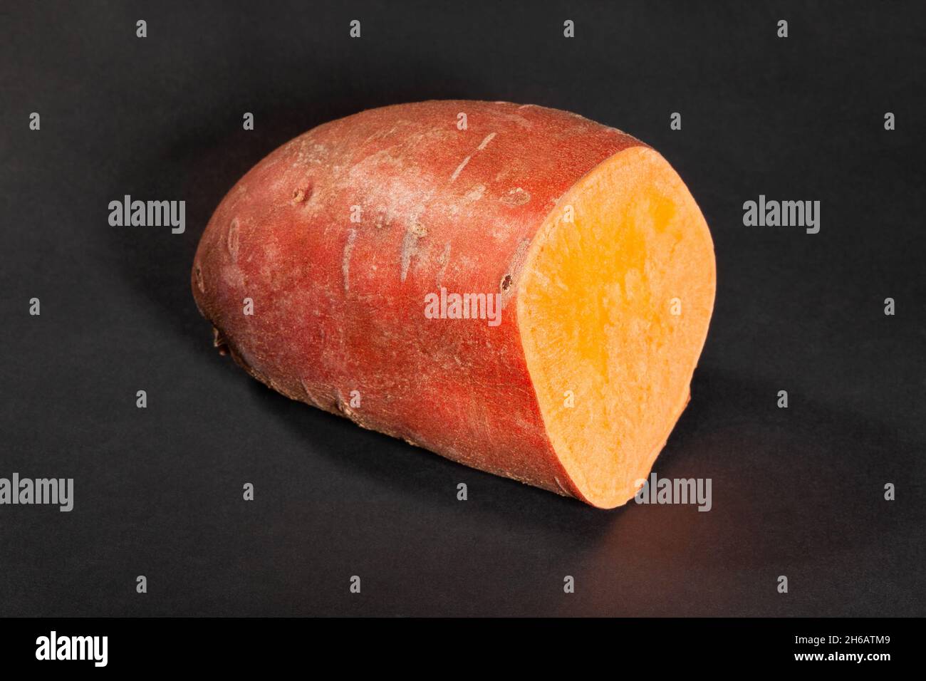 sliced sweet potato on black background Stock Photo