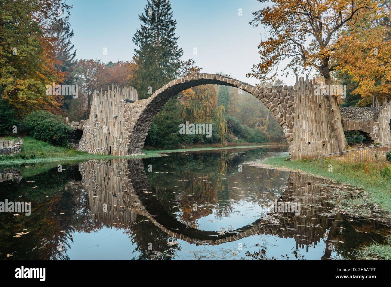 Unique looking bridge Rakotzbrucke,also called Devils Bridge,Saxony,Germany.Built to create circle when it is reflected in waters.Colorful fall Stock Photo