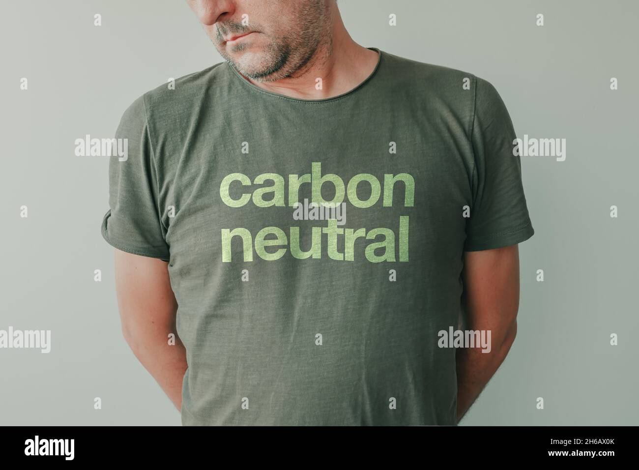 Man wearing green t-shirt with Carbon neutral text, portrait of environmentalist and environmental activist Stock Photo