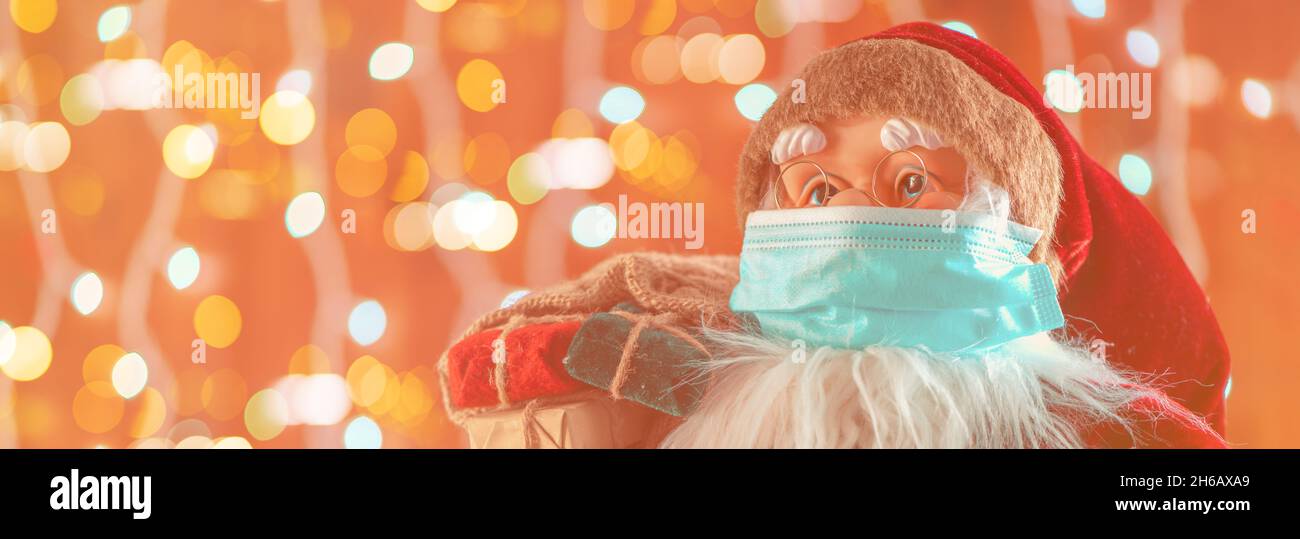 Santa Claus dummy toy with protective face mask for Covid-19 pandemics, selective focus Stock Photo
