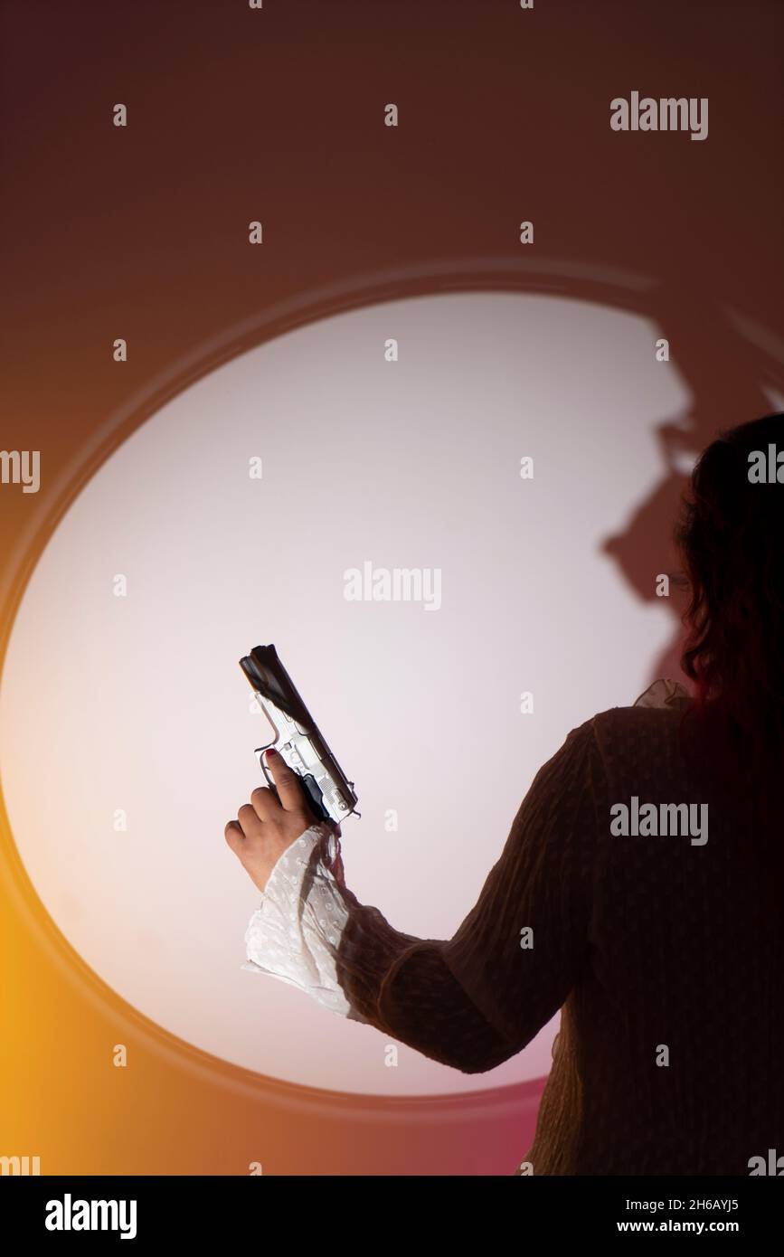 Lady spy detective holding pistol gun. Stock Photo