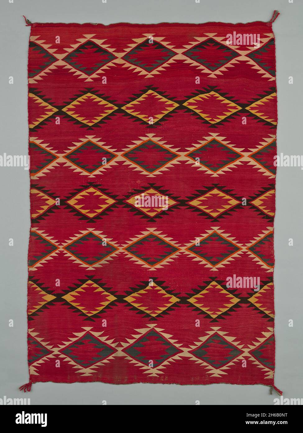 Sarape with Serrated Diamond Pattern, 1880/1900. A work made of wool, plain weave with &quot;lazy lines&quot; and dovetail tapestry weave; twined warp ends and selvages; looped and knotted corner tassels. Stock Photo