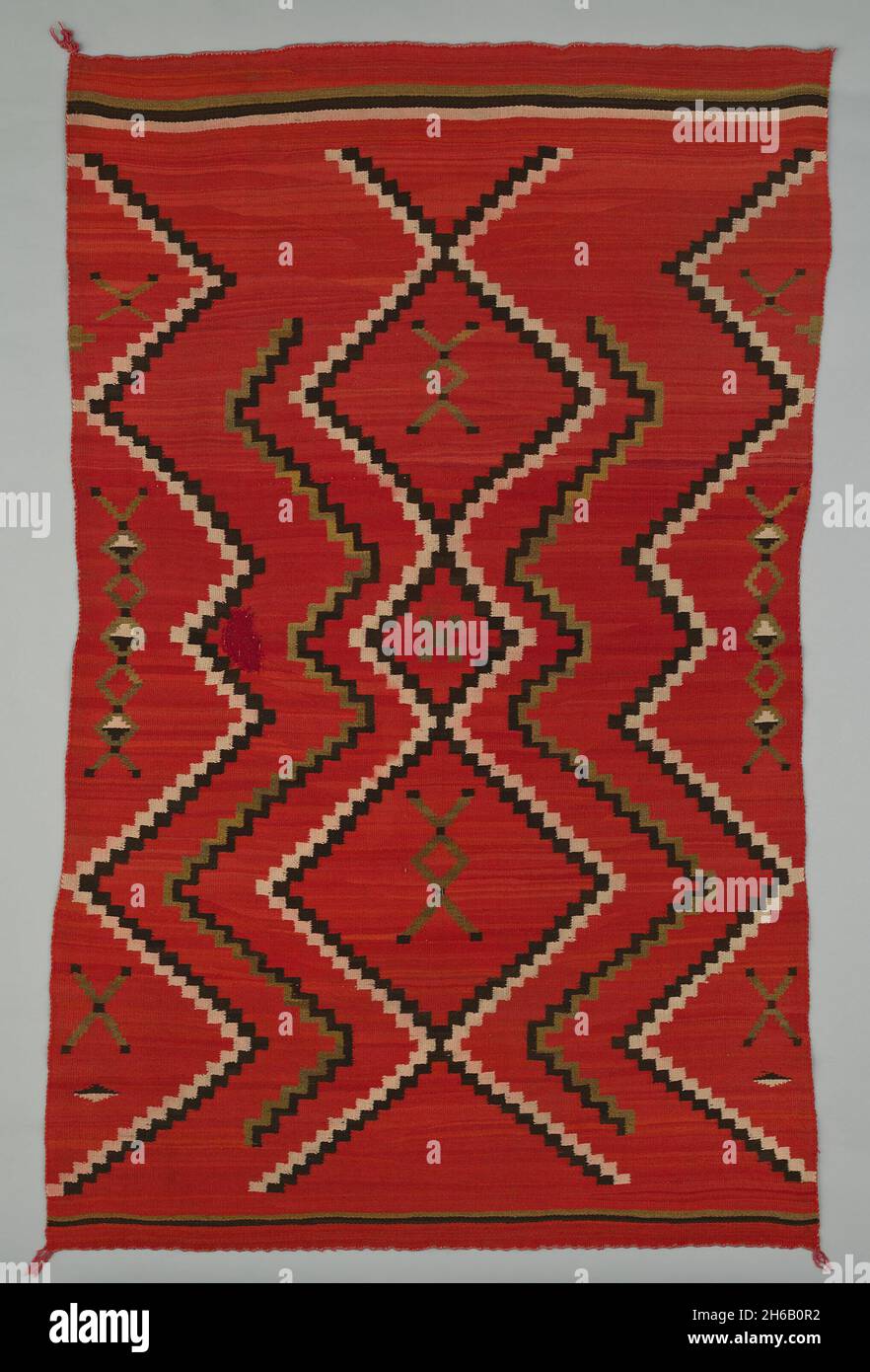 Sarape with Terraced Zigzag Design, 1865/85. A work made of wool, plain weave and dovetail tapestry weave; twined warp ends and selvages; looped and knotted corner tassels. Stock Photo