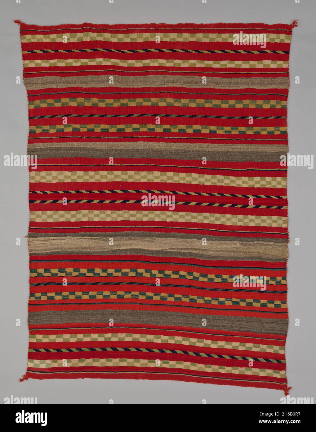 Sarape with Compound Banded Design, 1870/95. A work made of wool, plain weave and single interlocking tapestry weave; twined warp ends and selvages; looped and knotted augmented corner tassels. Stock Photo