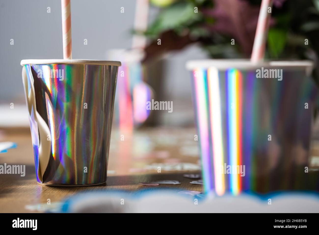 Purple silver extremely bright drinking glass on a birthday party close up still Stock Photo