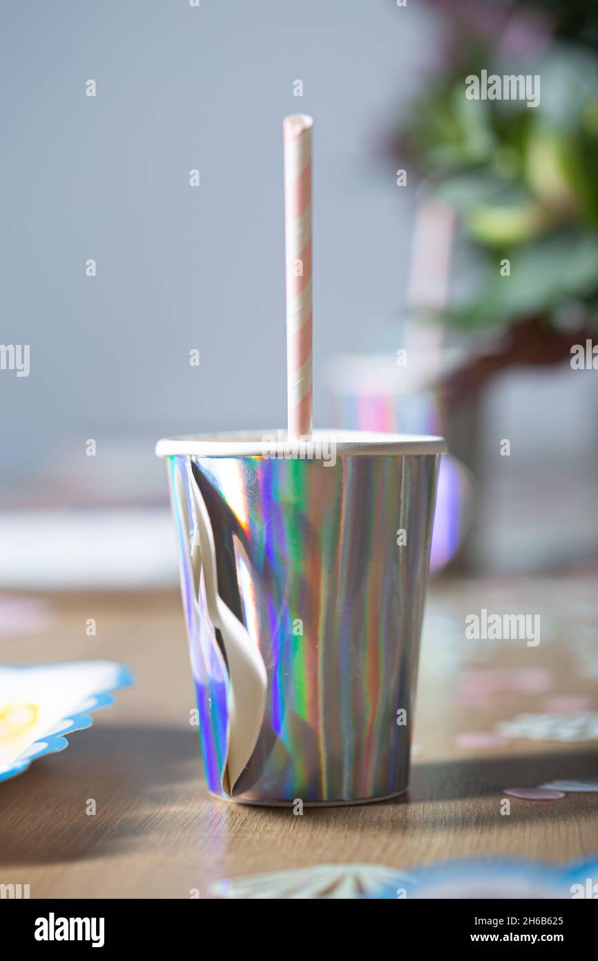 Purple silver extremely bright drinking glass on a birthday party close up still Stock Photo