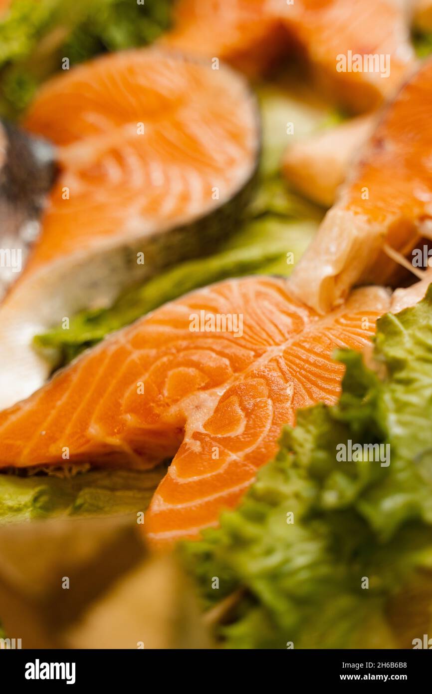 Salmon steaks with lettuce close-up. Fresh raw red fish Stock Photo - Alamy