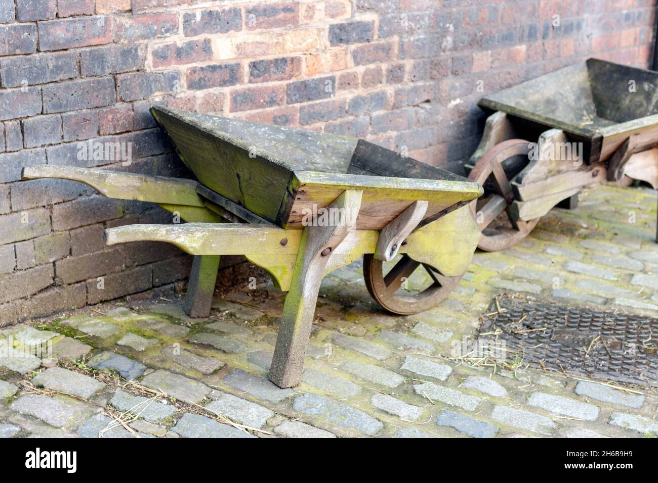old wooden wheelbarrow at Gladstone Pottery Museum, Longton, Stoke on trent Stock Photo