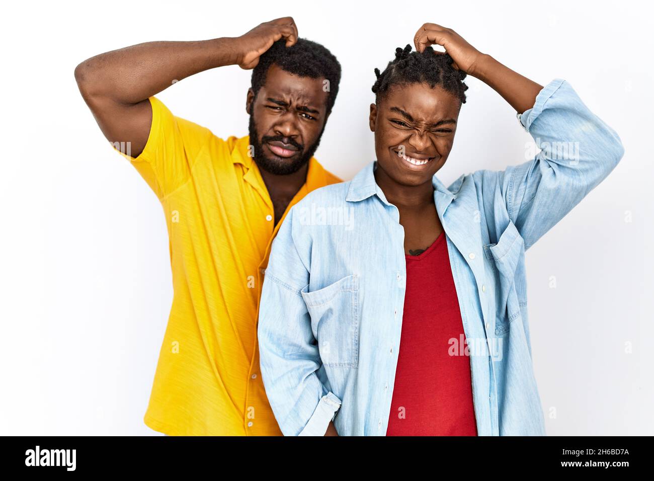 Young african american couple wearing casual clothes confuse and wonder ...