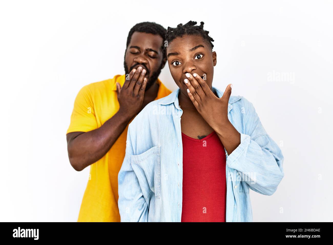 Young african american couple wearing casual clothes bored yawning ...