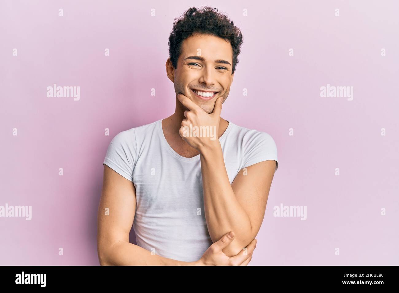 Young handsome man wearing casual white t shirt looking confident at ...
