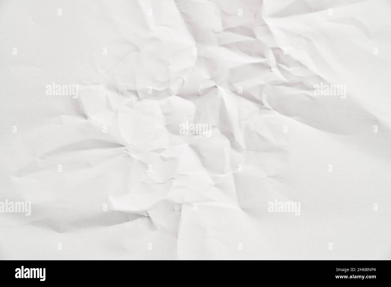 White crumpled paper texture with wrinkles. Damaged and torn sheet