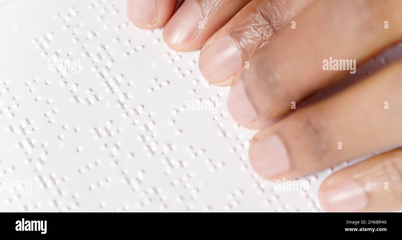 Black fingers are reading braille Stock Photo