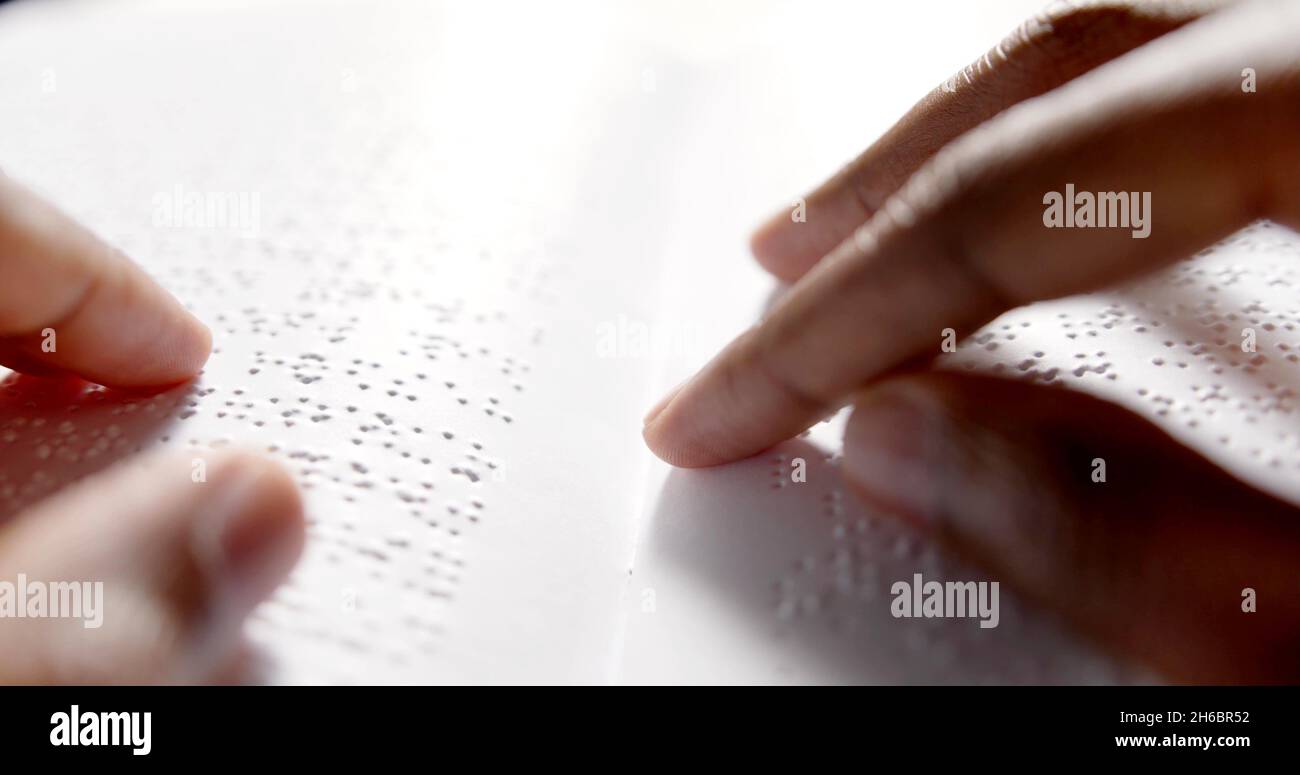 Black hands are reading braille Stock Photo