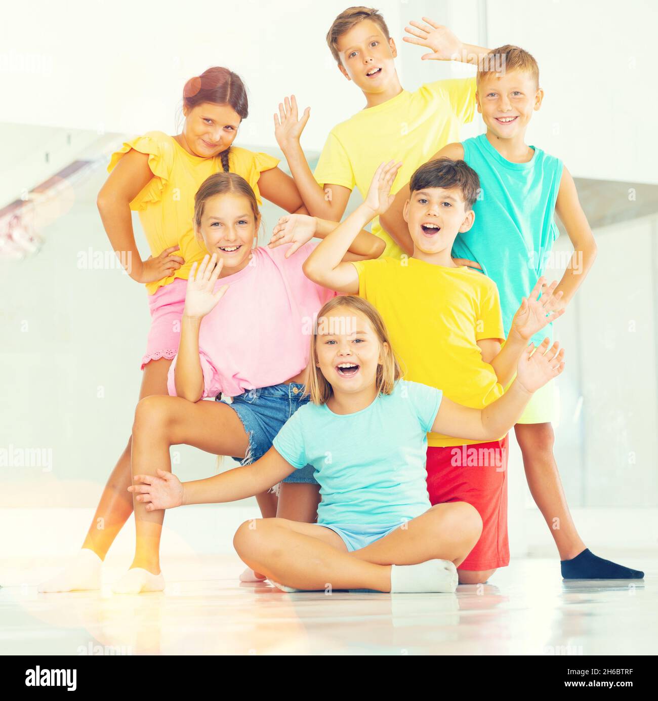Cheerful preteen boys and girls posing in choreography class Stock Photo