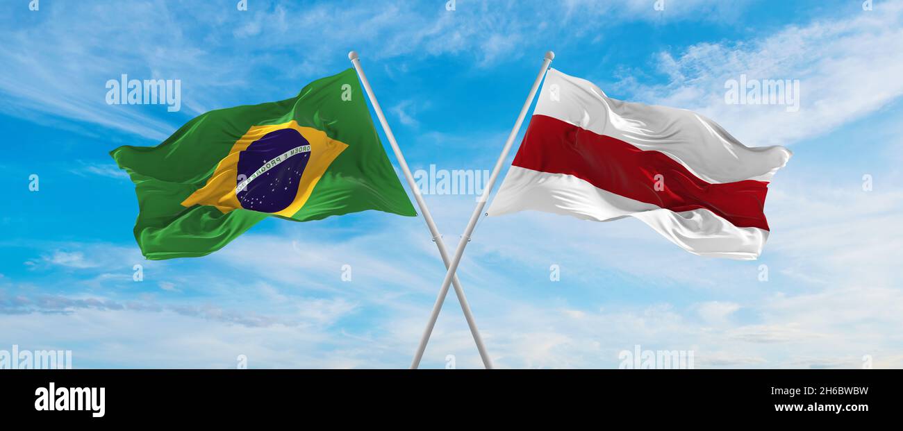 crossed national flags of Brazil and Belarus flag waving in the wind at ...