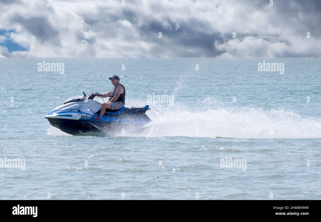 Yamaha Waverunner VX personal watercraft on Lake Michigan at Two Rivers, Wisconsin piloted by mature man. Stock Photo