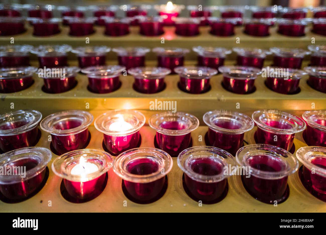 prayer candle votives in a row in church Stock Photo Alamy