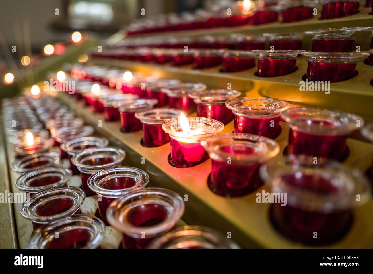 prayer candle votives in a row in church Stock Photo Alamy