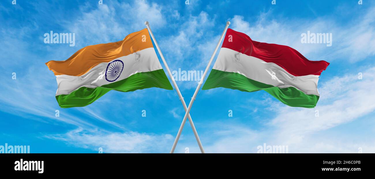 crossed national flags of India and Hungary flag waving in the wind at ...