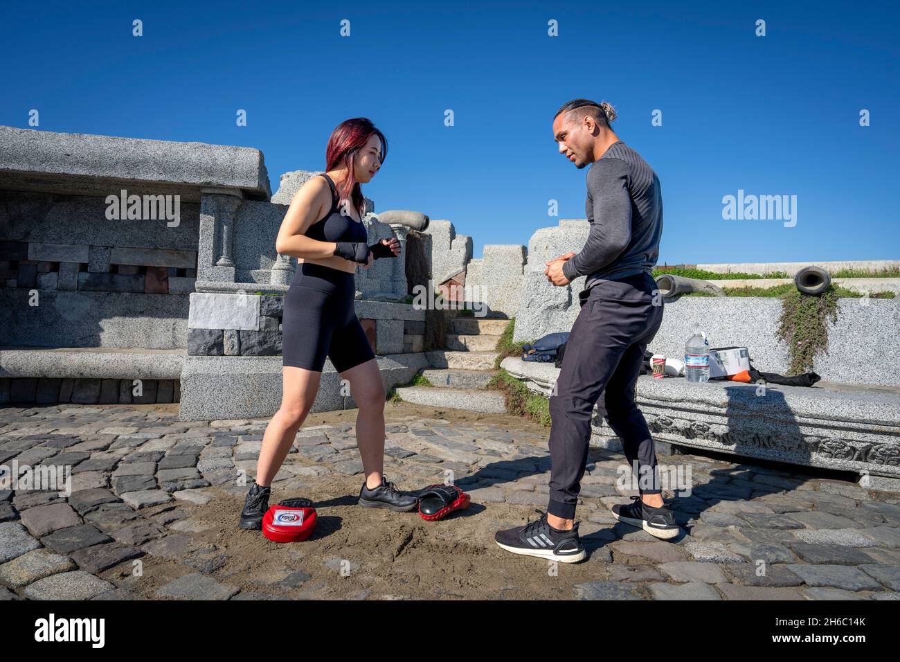 Young Asian Woman Taking First MMA Training Session with Personal Trainer Stock Photo