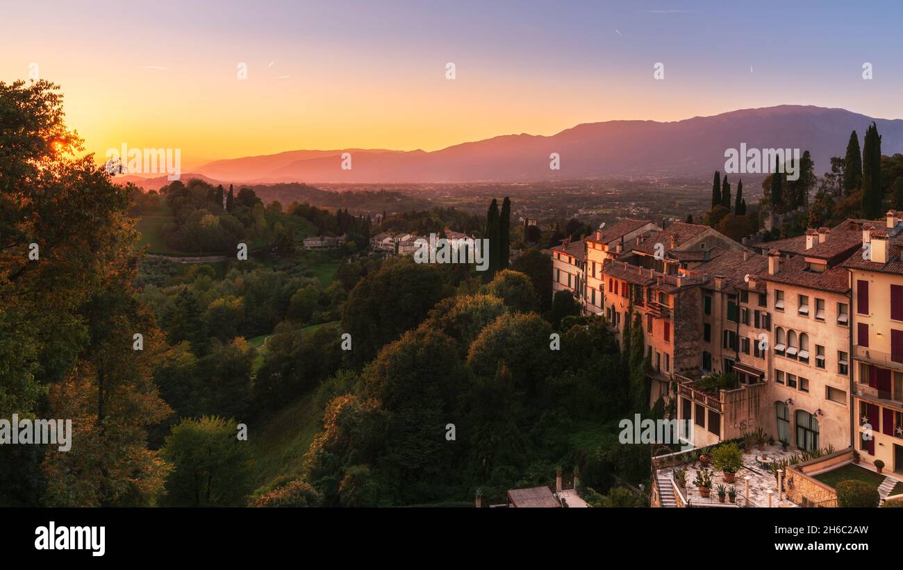 Scenic view of Asolo (Treviso province, veneto, Italy) ancient buildings and countryside at sunset in autumn, mountains on the background Stock Photo