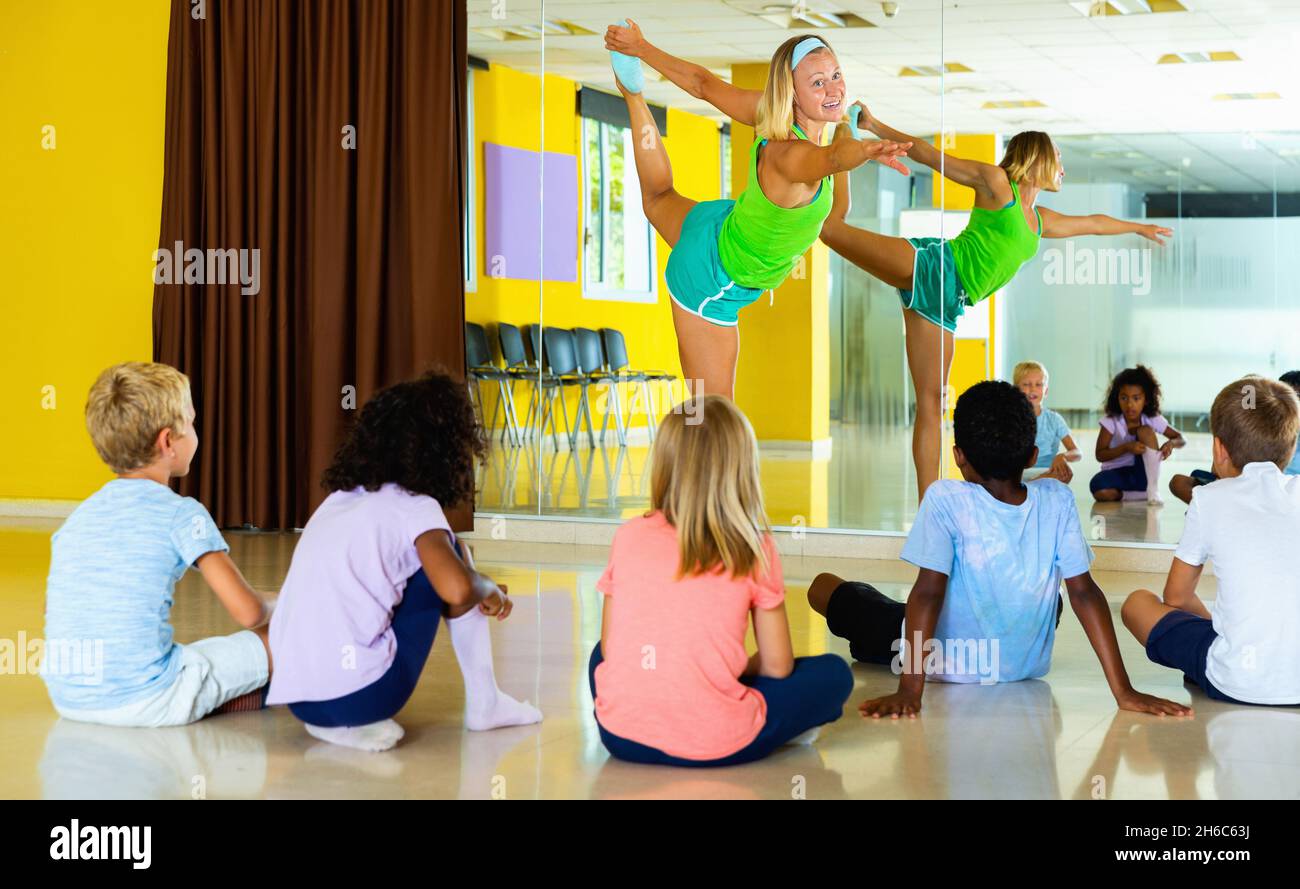 Experienced positive dance instructor teaching preteen boys and Stock Photo