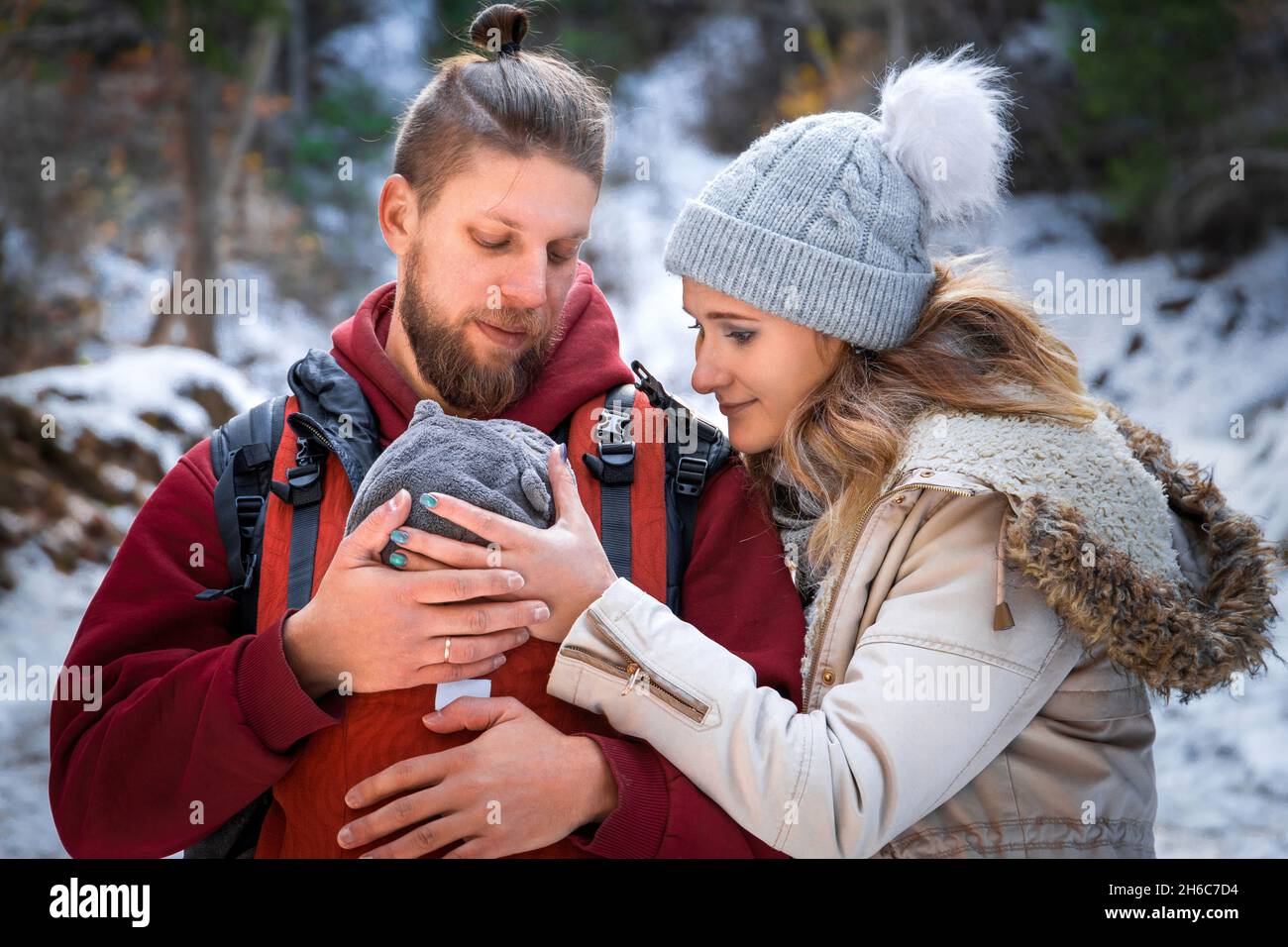 Winter outdoor walk of a young family with their newborn baby Stock