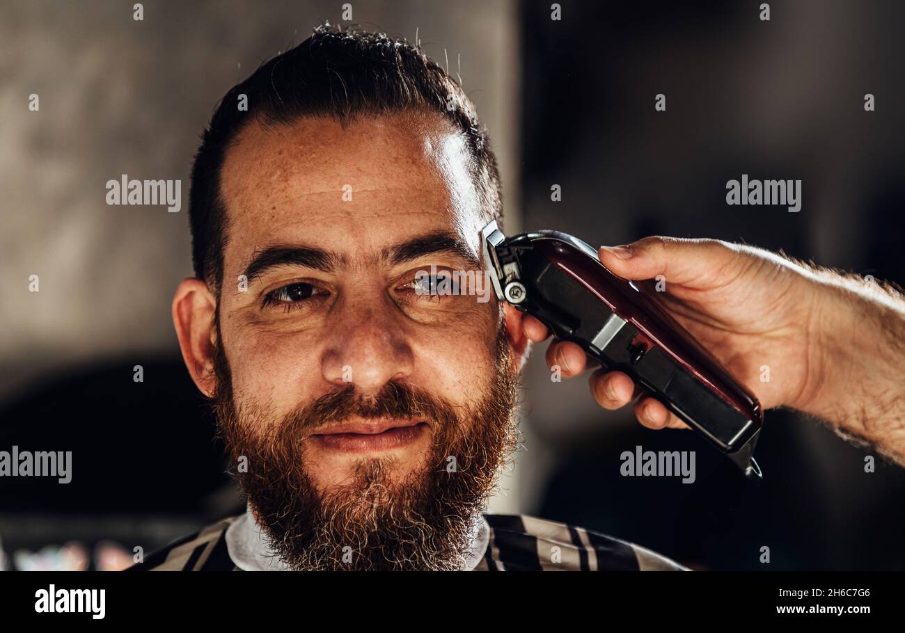 Closeup of trimmer machine. Process of trimming of hair in barber shop