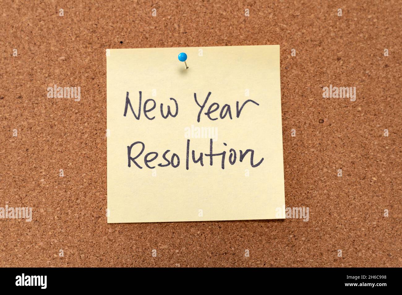New Year resolution written on yellow sticky note pad Stock Photo