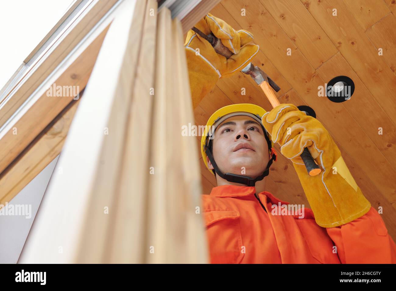 Contractor removing old wooden window frames in house before installing new ones Stock Photo Alamy