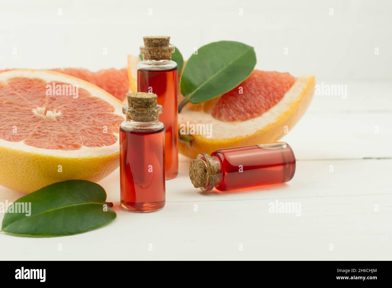 bottles with natural essence or grapefruit essential oil for selfcare, aromatherapy, spa