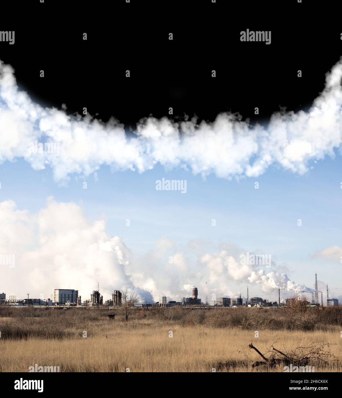 Air pollution smoke from factory pipes. Industrial smokestacks. Smoke from factory chimneys and blue and dark sky. Environmental pollution. Waste prod Stock Photo