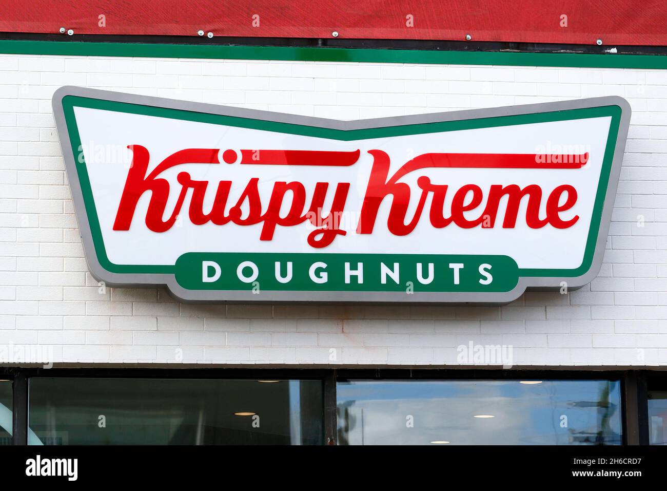 Krispy Kreme doughnuts signage on a wall of a retail store. Stock Photo