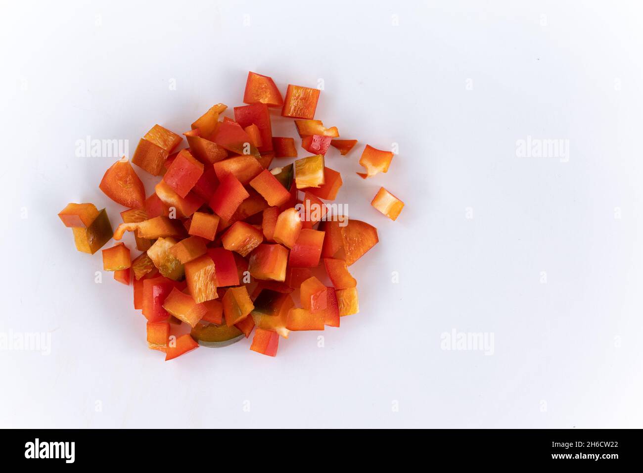 red chopped sweet bell pepper isolated on white background, top view, raw vegetables, harvest new of red peppers Stock Photo