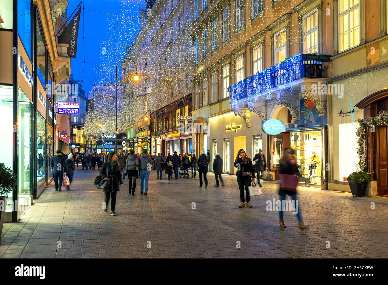 People walking on the street in the city center illuminated and decorated for Christmas holidays in Vienna, Austria. Stock Photo