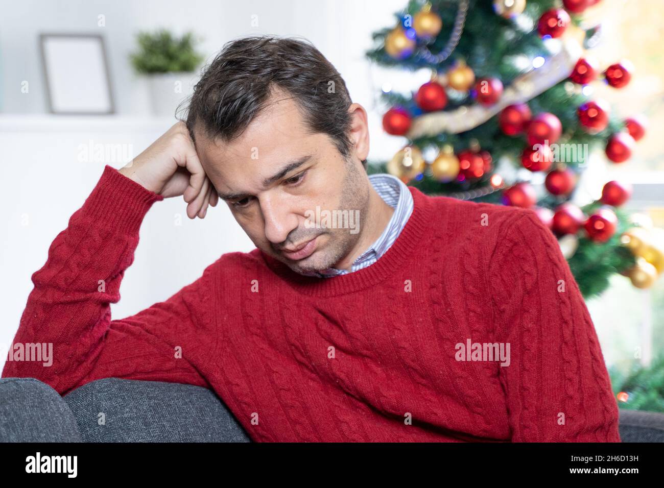 One sad man suffering christmas holiday anxiety Stock Photo - Alamy