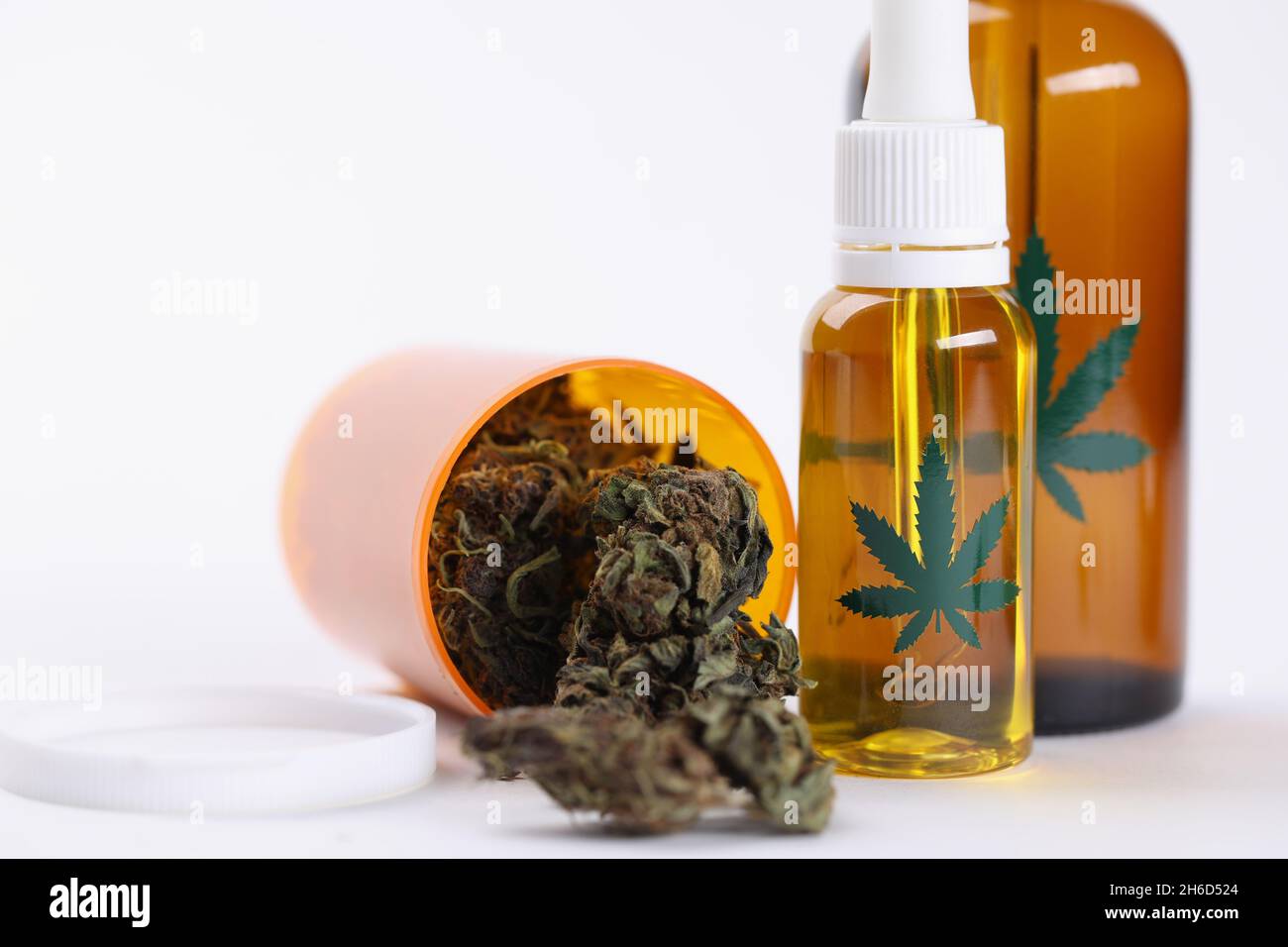 Dry marijuana buds extract oil and spray in plastic bottles Stock Photo