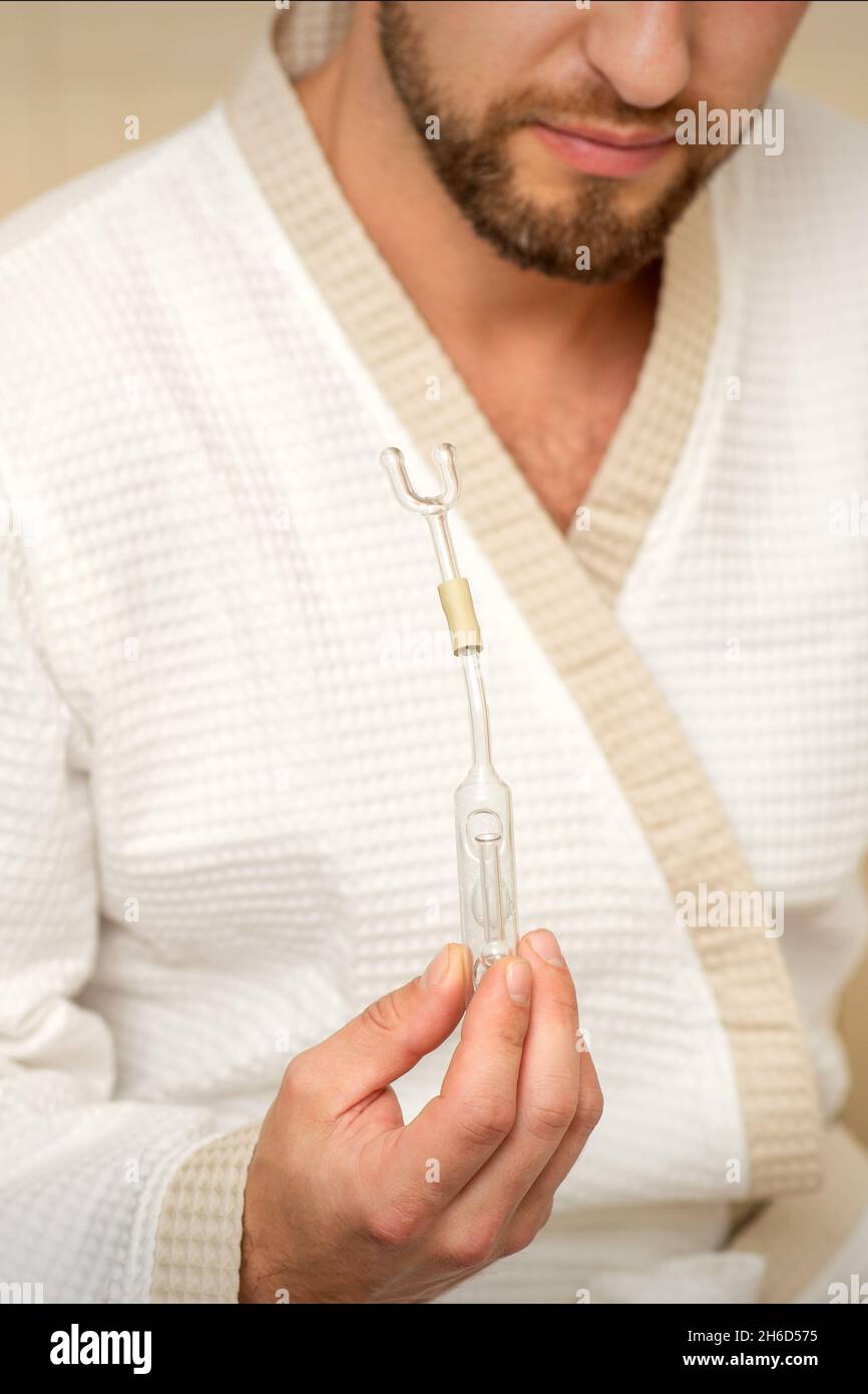 Young caucasian man receiving nasal inhalation Maholda with essential ...