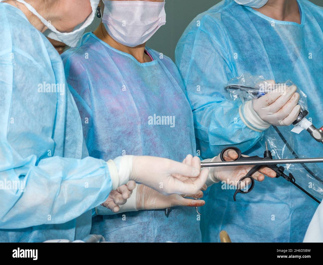 Selective focus on the hands of a surgeon with medical instruments