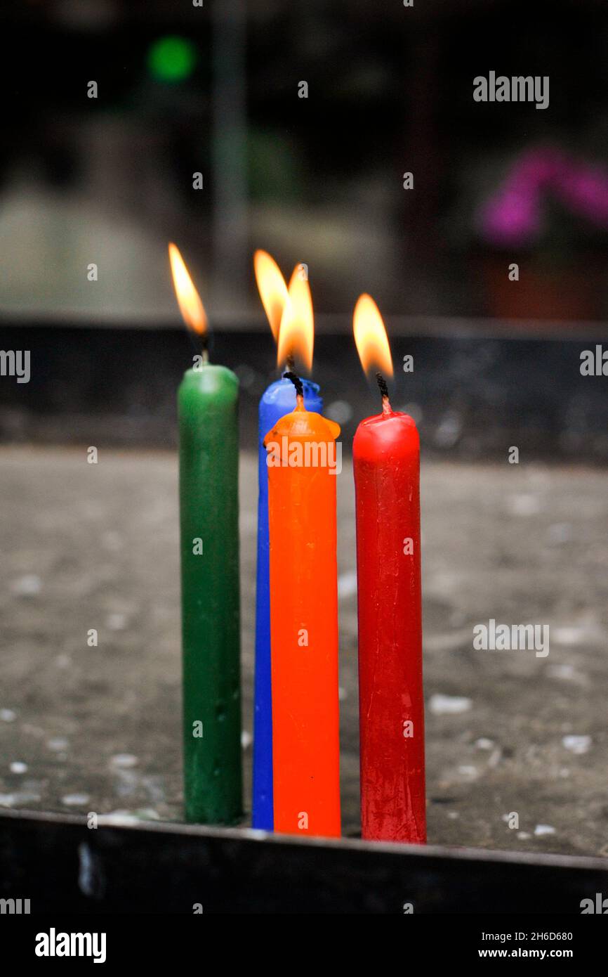 Colored candles in a church.  Virgen del Guayco sanctuary.  Chimbo, Ecuador Stock Photo