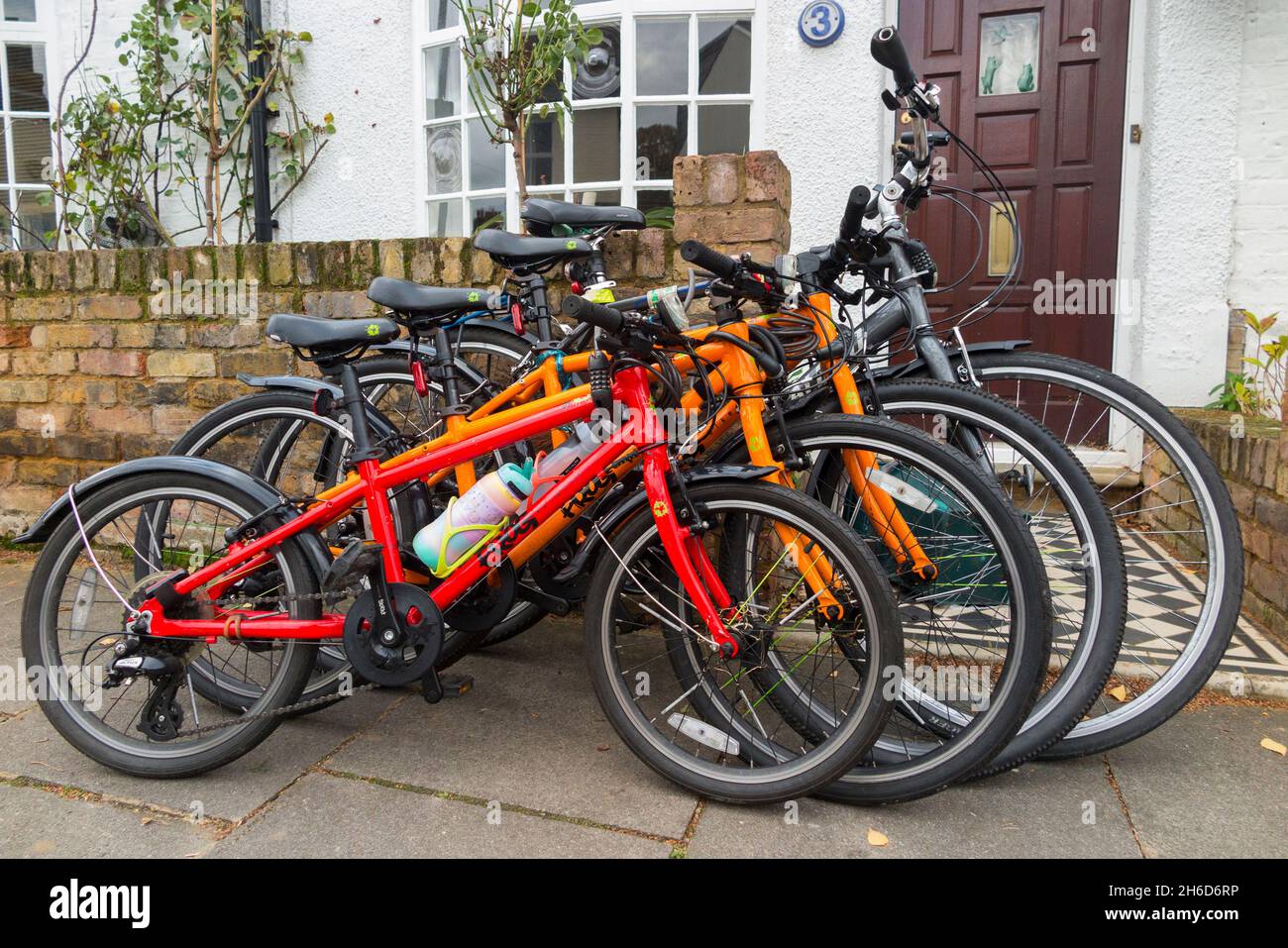Four bicycles / bikes / 4 cycles locked sales outside the home of a