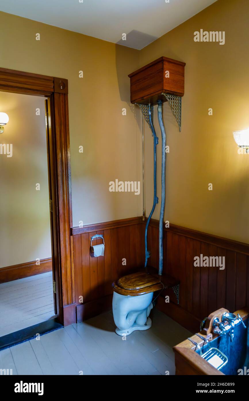 Old Fashioned high level flush toilet and cistern in the 1890 Farm House museum, Billings Farm & Museum, Woodstock, Vermont, New England, USA Stock Photo