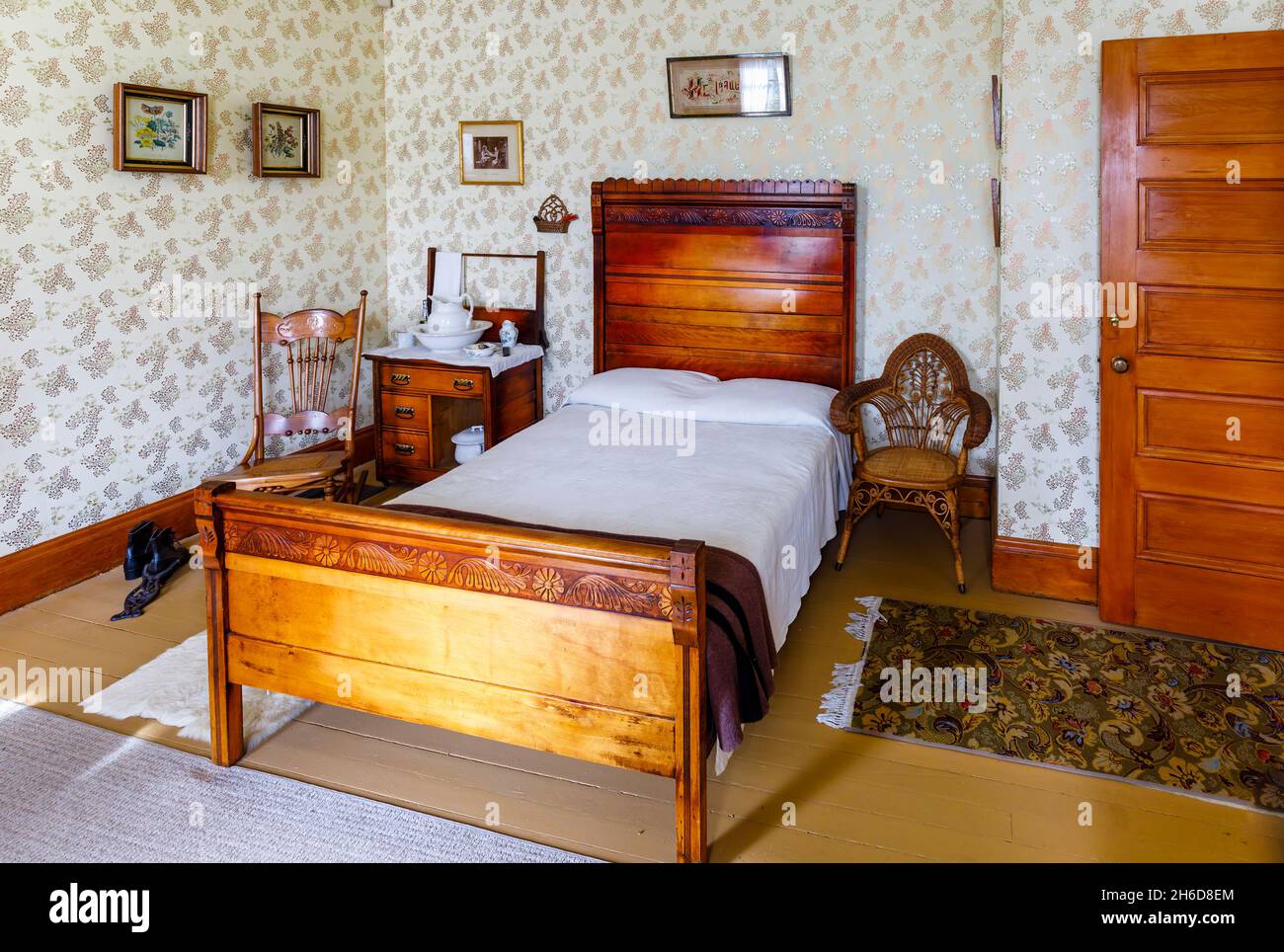 Traditional 19th century bedroom and carved wooden double bed in the