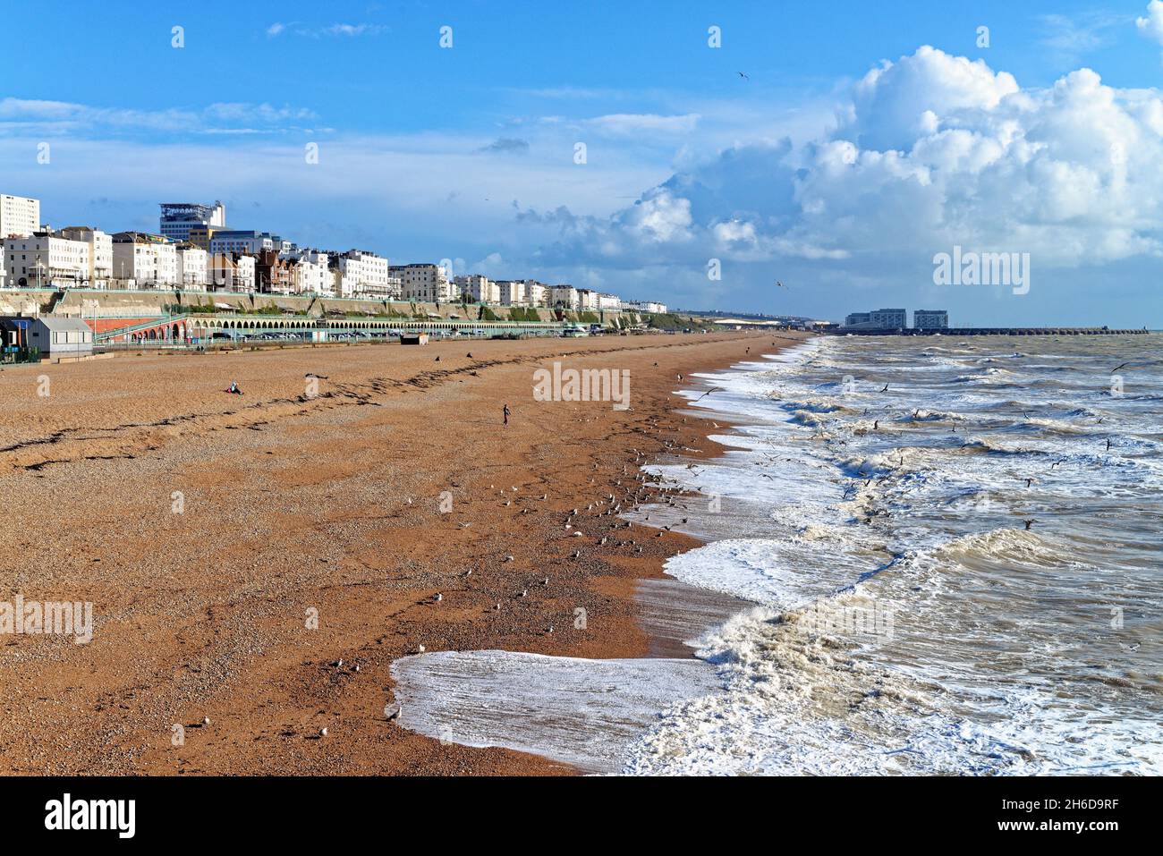The view of Brighton seafront looking east from the Palace Pier towards Kemp Town on a sunny autumn day East Sussex England UK Stock Photo